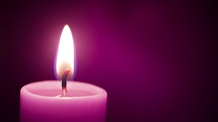 burning candle on black background