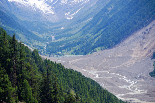 Fototapeta Aerial view of rockfall with gravel and Lonza River at Lötschental Valley in the Swiss Alps covering almost entire mountain village of Blatten. Photo taken June 19th, 2025, Wiler, Switzerland.