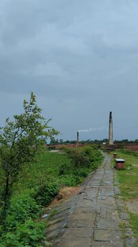 Scenic Brick Kiln Landscape with Smokestacks under Overcast Sky 4k video