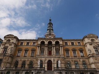 Obraz premium Bilbao Spain 16 06 2025 Bilbao City Hall building seen from the riverside. A historic architectural landmark reflecting the city's civic pride and cultural heritage.