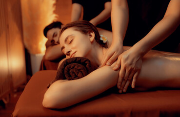 Caucasian couple customer enjoying relaxing anti-stress spa massage and pampering with beauty skin...