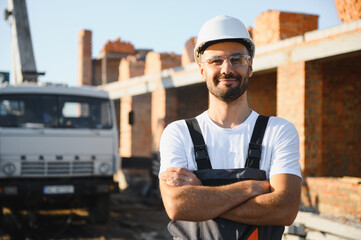 Construction worker in uniform and safety equipment have job on building