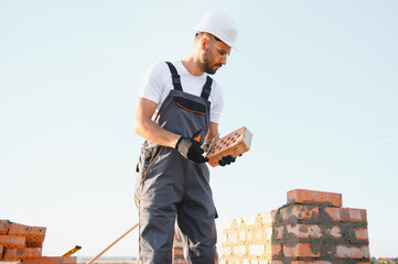 Construction worker in uniform and safety equipment have job on building