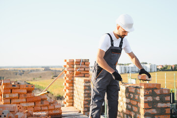 Construction worker in uniform and safety equipment have job on building