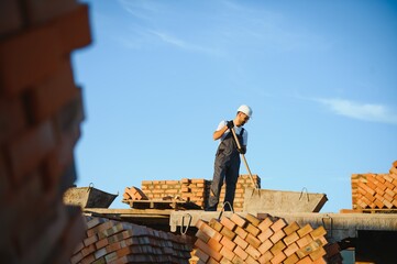 Construction worker in uniform and safety equipment have job on building