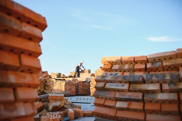 Construction worker man in work clothes and a construction helmet. Portrait of positive male...
