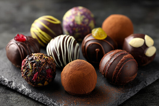 Luxury handmade decorative chocolate bonbon in a display of assorted pralines. AI Generative