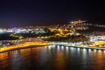 Picturesque night view of Al Hoceima city and modern hotel buildings on the shore of the Mediterranean Sea bay