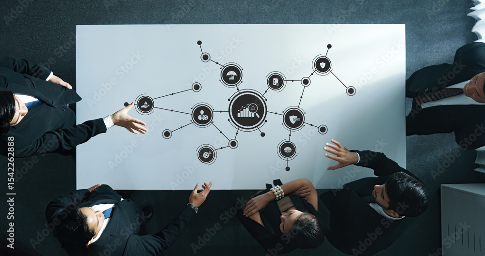 Poster a dynamic overhead view of a professional team engaged in a collaborative meeting, analyzing data an