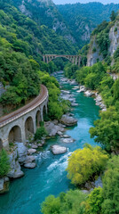 Serene River Crossing: Captivating aerial view of a historic railway arch bridge elegantly traversing a serene turquoise river that winds through a verdant valley.