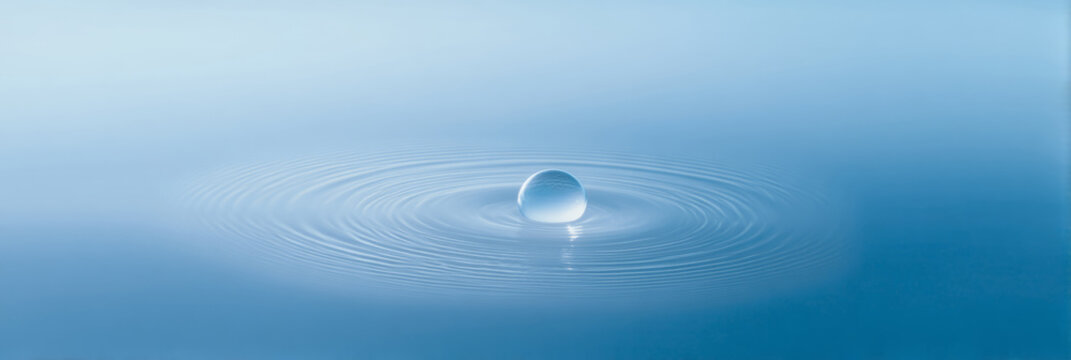 glowing soap bubble floating in middle of soft blue mist and gentle sudsy ripples