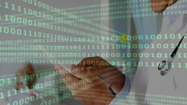 Senior physician glancing at gowned patient then browsing tablet for records with binary code