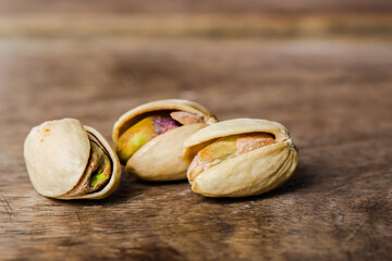 Roasted and salted pistachio on wooden table