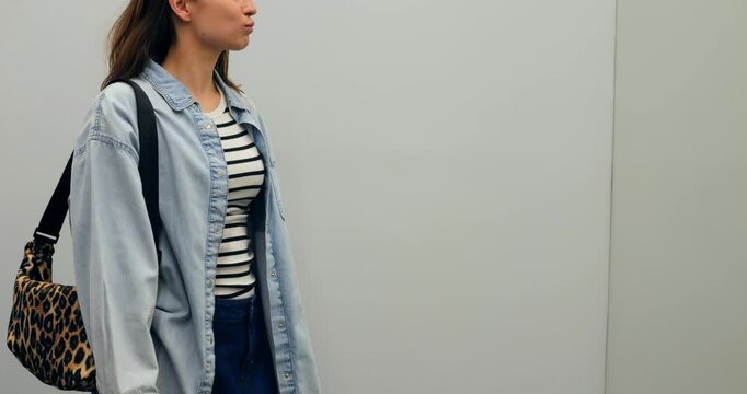Fashion model posing with leopard print hobo bag, presenting styling versatility against pristine white studio backdrop. Highlighting contemporary urban accessory with confident, chic aesthetic