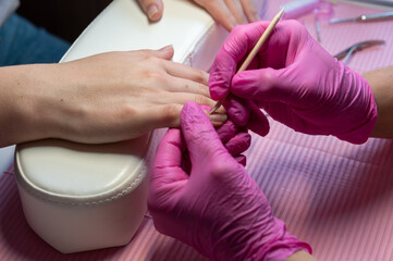 Cuticle Care During Manicure Procedure – Close-Up in Beauty Salon, Close-up of a professional...