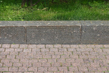 granite curb on green lawn, cobblestone pavement, gray curbstone, 2