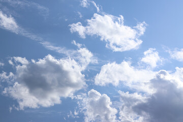 White clouds against the blue sky. Sky background. Summer. Landscape. Soft white clouds against the blue sky. Calm and serene atmosphere. White fluffy clouds
