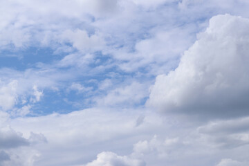White clouds against the blue sky. Sky background. Summer. Landscape. Soft white clouds against the blue sky. Calm and serene atmosphere. White fluffy clouds