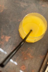 a glass of orange juice in a glass with a straw