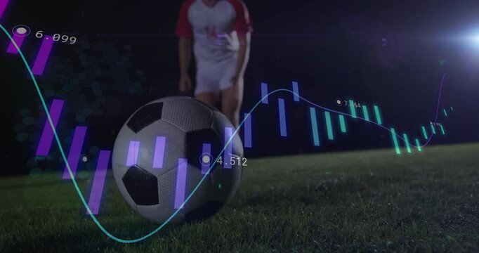 male player starting run-up toward soccer ball on floodlit pitch with stats overlay analyzing shot