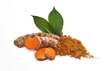 Turmeric Roots and Powder. Fresh turmeric roots and powder with green leaves against a white background.