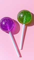 Brightly colored lollipops resting on a pastel pink background create a playful, cheerful atmosphere for sweet candy lovers