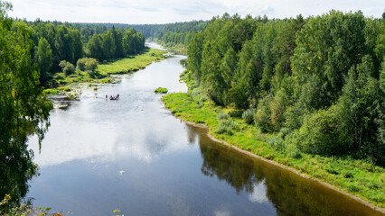 Rafting on Chusovaya river against background of coniferous trees and greenery on sunny summer day, Ural, Sverdlovsk region, Russia