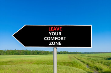 Leave your comfort zone symbol. Concept words Leave your comfort zone on beautiful road sign. Beautiful blue sky grass background. Business psychological Leave your comfort zone concept. Copy space.