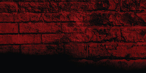 Rustic block wall illuminated by a dark, intense light, revealing its intricate structure and time-worn imperfections with deep shadows.
