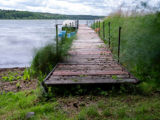 A jetty and two boats in high winds. Summer time.