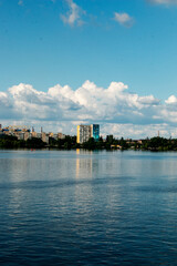 Naklejka premium Panoramic view of the left bank of the Dnieper River. Ukraine. The city of Dnieper. Reflection of the sky with clouds on water surface.