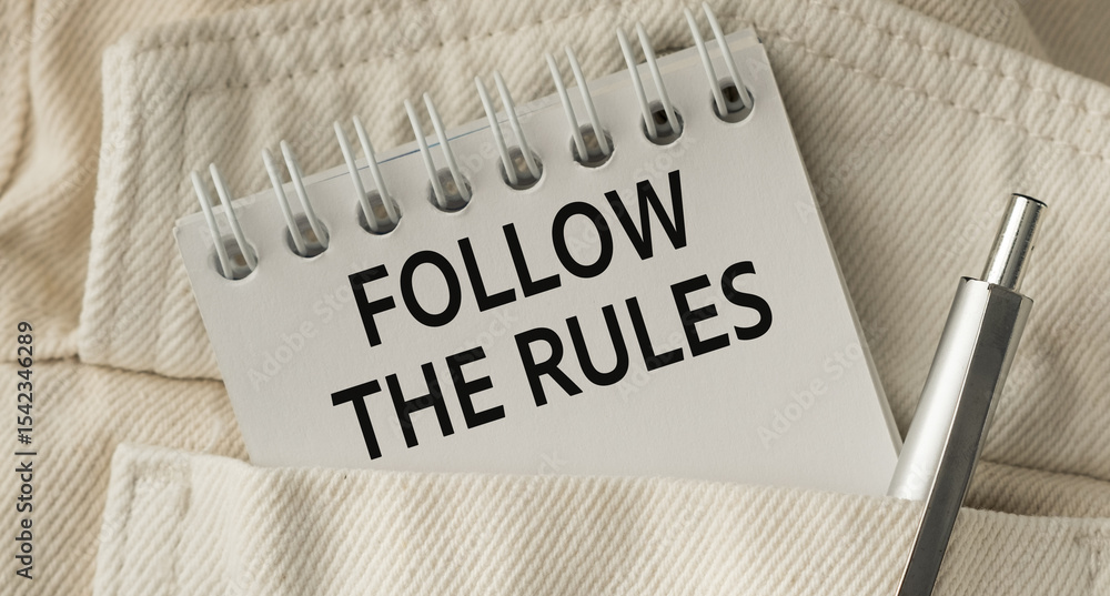 Poster a pen is sitting on a notebook that says follow the rules