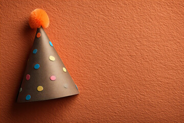 Colorful Party Hat on Burnt Orange Background