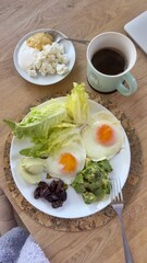 Well-balanced breakfast featuring healthy source of ptotein, fermented and fresh vegetables, salad and nuts on a plate. Top view real kitchen photo, diet and self care and love concept	