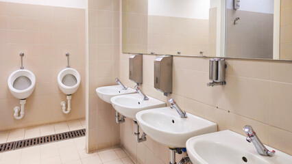 Interior of a bathroom with toilets. Design of sanitary facilities for personal care. Personal hygiene in public places. Ceramic products in everyday life.