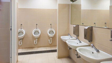 Interior of a bathroom with toilets. Design of sanitary facilities for personal care. Personal hygiene in public places. Ceramic products in everyday life.