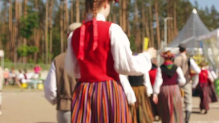 Dance, sunlight, and national dress create vivid impressions for cultural explorers.