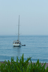 Yachting on a serene seascape at sea. A lone ship sailing on the water on a sunny summer day. Frontal view