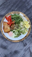 Well-balanced breakfast featuring healthy source of ptotein, fermented and fresh vegetables, salad and nuts on a plate. Top view real kitchen photo, diet and self care and love concept
