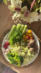 Well-balanced breakfast featuring healthy source of ptotein, fermented and fresh vegetables, salad and nuts on a plate. Top view real kitchen photo, diet and self care and love concept
