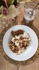 Well-balanced breakfast featuring healthy source of ptotein, fermented and fresh vegetables, salad and nuts on a plate. Top view real kitchen photo, diet and self care and love concept