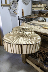 Luthier using traditional rope technique to hold guitar body together