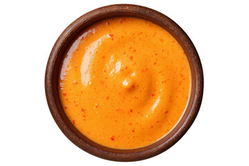 A bowl of red sauce sits on a white background