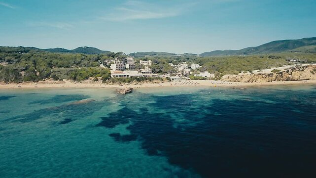 Drone Shot from the Sea Approaching the Beach of Es Figueral in Ibiza