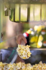 Old popcorn machine for making popcorn in the park. Children's corn attraction. Making healthy food.