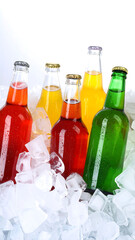 Ice-cold drinks in glass bottles and cans on ice