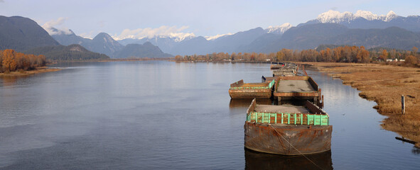Barges sleeping on the river from snowy mountains