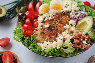 A bowl with cobb salad, traditional American dish