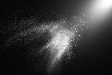 Floating dust particles illuminate a black matte background, creating a captivating and ethereal atmosphere in a creative and artistic display of light and texture