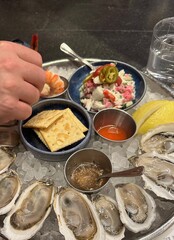 for dinner - a platter of fresh New England oysters with cocktail and mignonette sauces, a side of ceviche